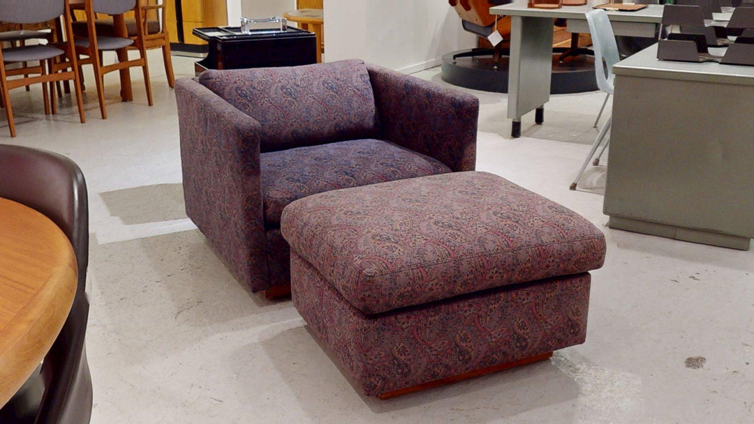 Purple paisley upholstered club chair and matching ottoman, boxy track-arm silhouette